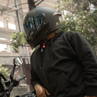 motorcycle-rider-in-all-black-gear-wearing-hax-black-pearl-full-face-helmet