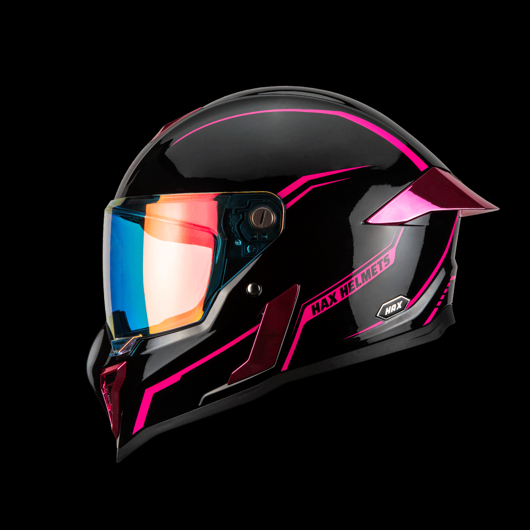 hax black pearl full-face motorcycle helmet in black with pink accents and mirrored visor on studio background