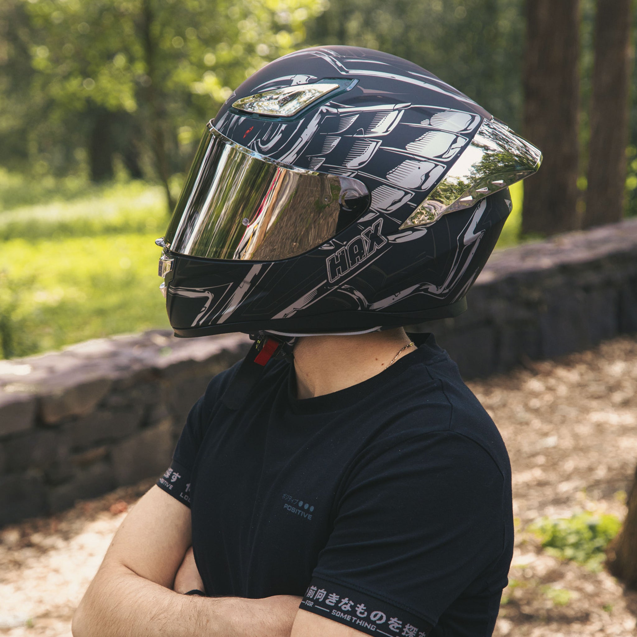 rider-posing-with-hax-onix-rapha-full-face-helmet-in-forest-environment