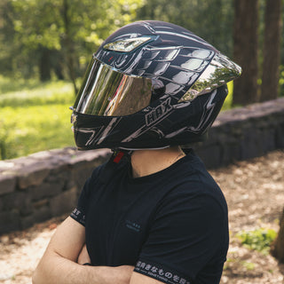 rider-posing-with-hax-onix-rapha-full-face-helmet-in-forest-environment